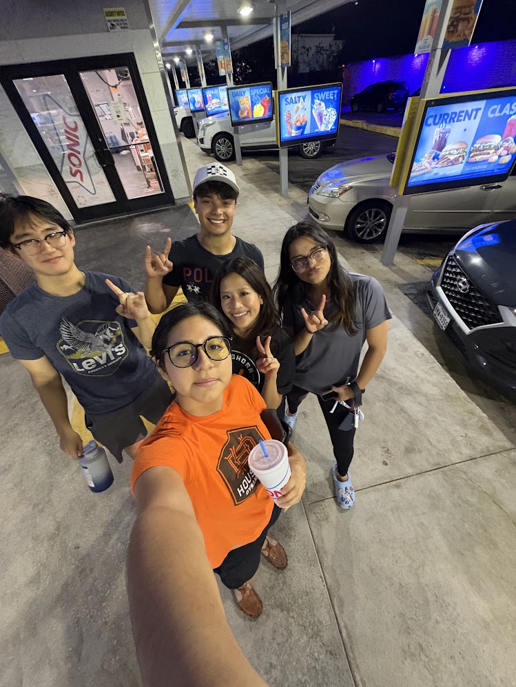 Friends in a Sonic parking lot at night