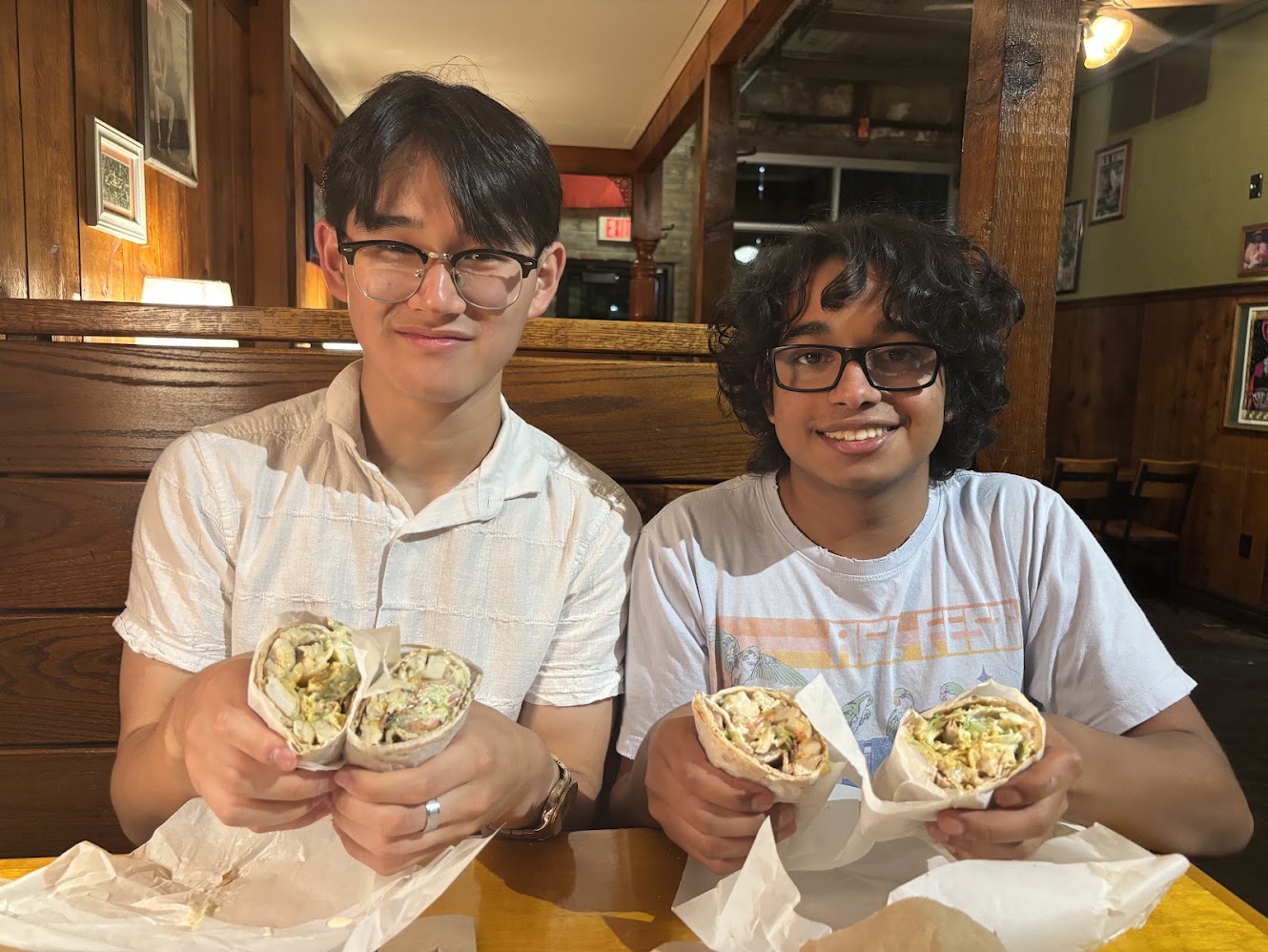 Feifan and a friend holding wraps at a restaurant